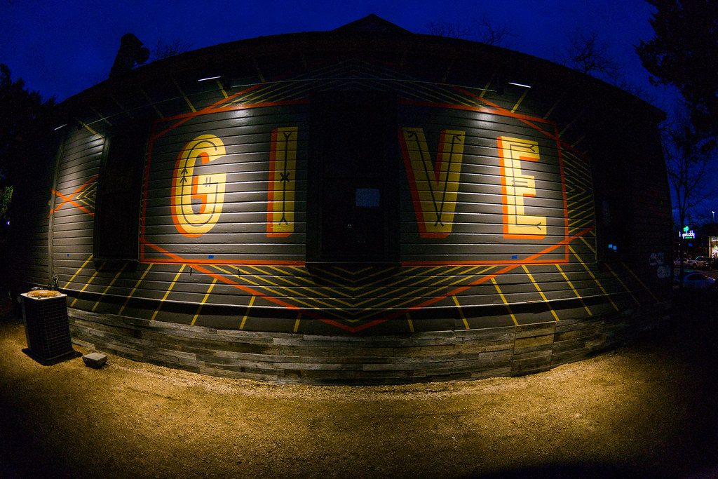 give sign on TOMS south congress 